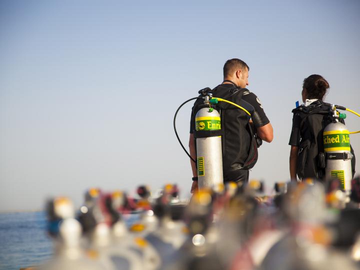 Two divers with air nitrox tank.