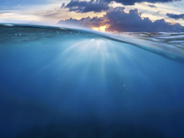 Underwater with sky above